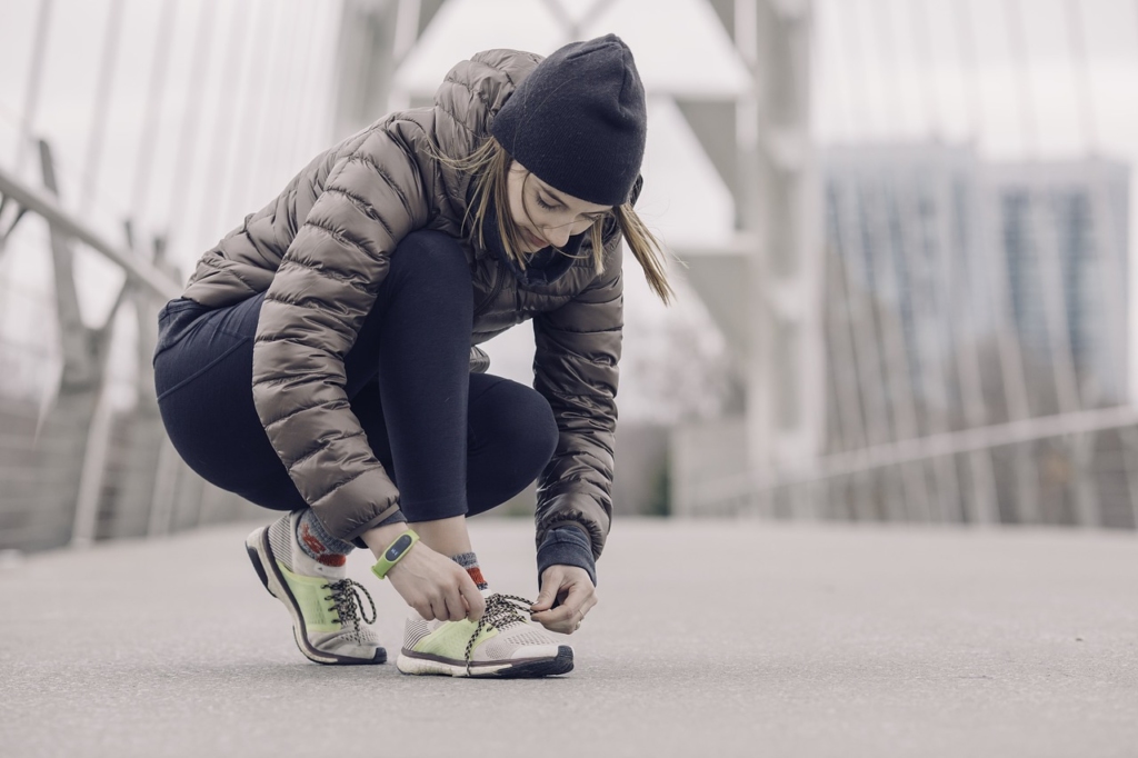 woman running with fitness tracker