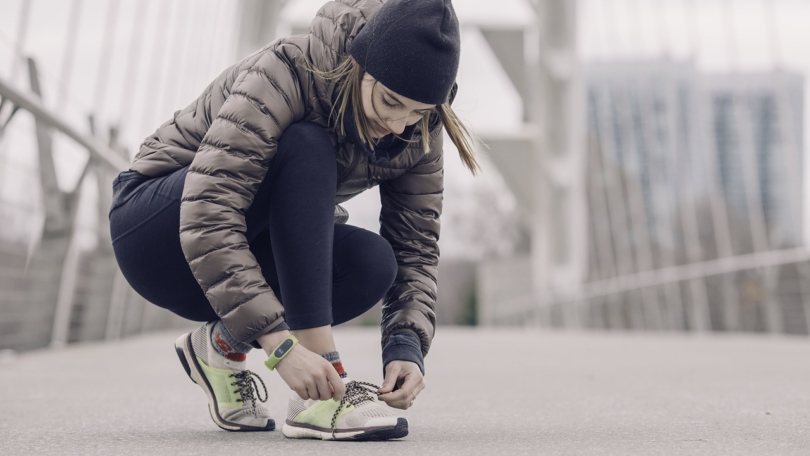 woman running with fitness tracker